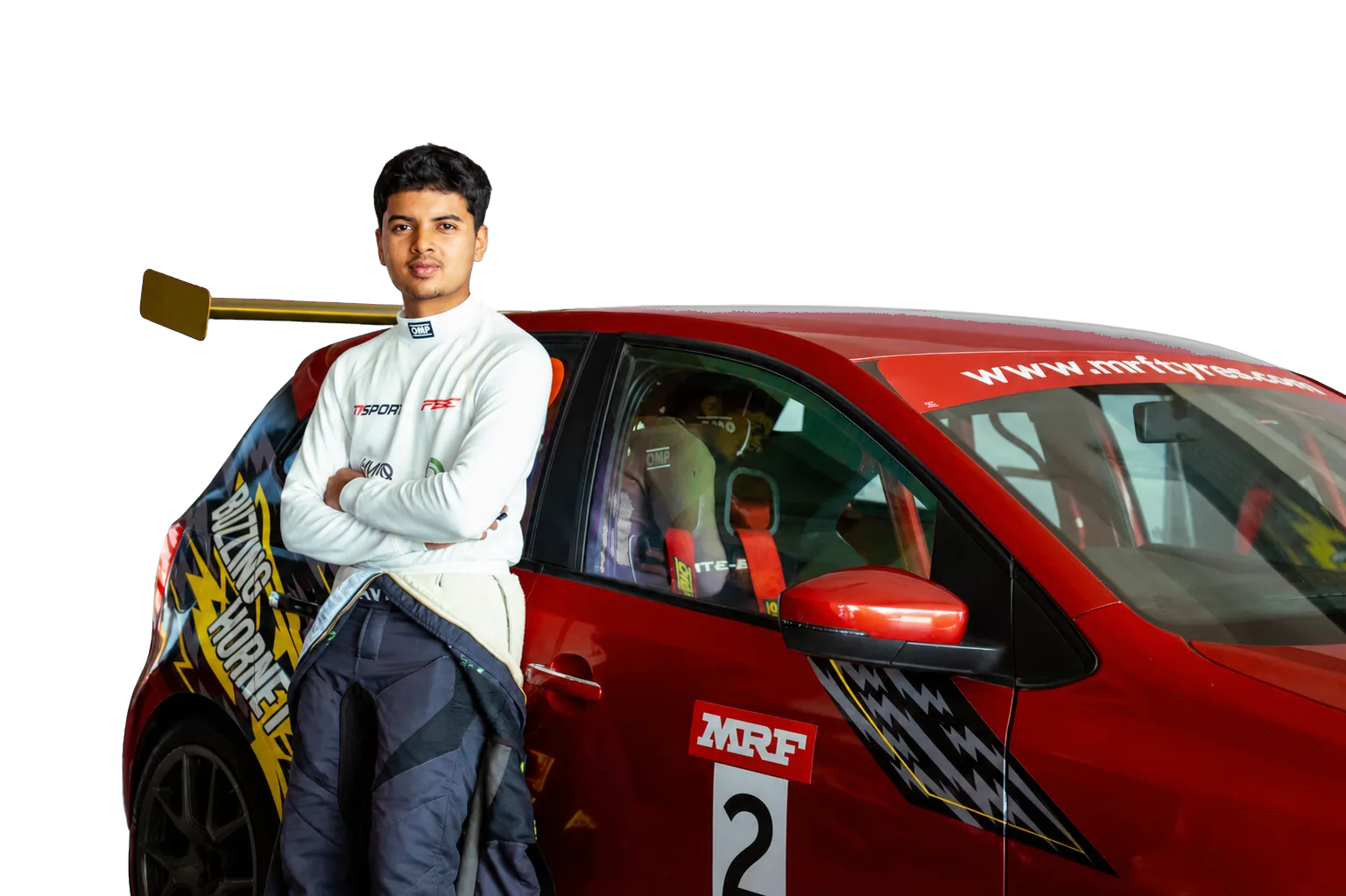 Avi Malavalli standing beside his red race car